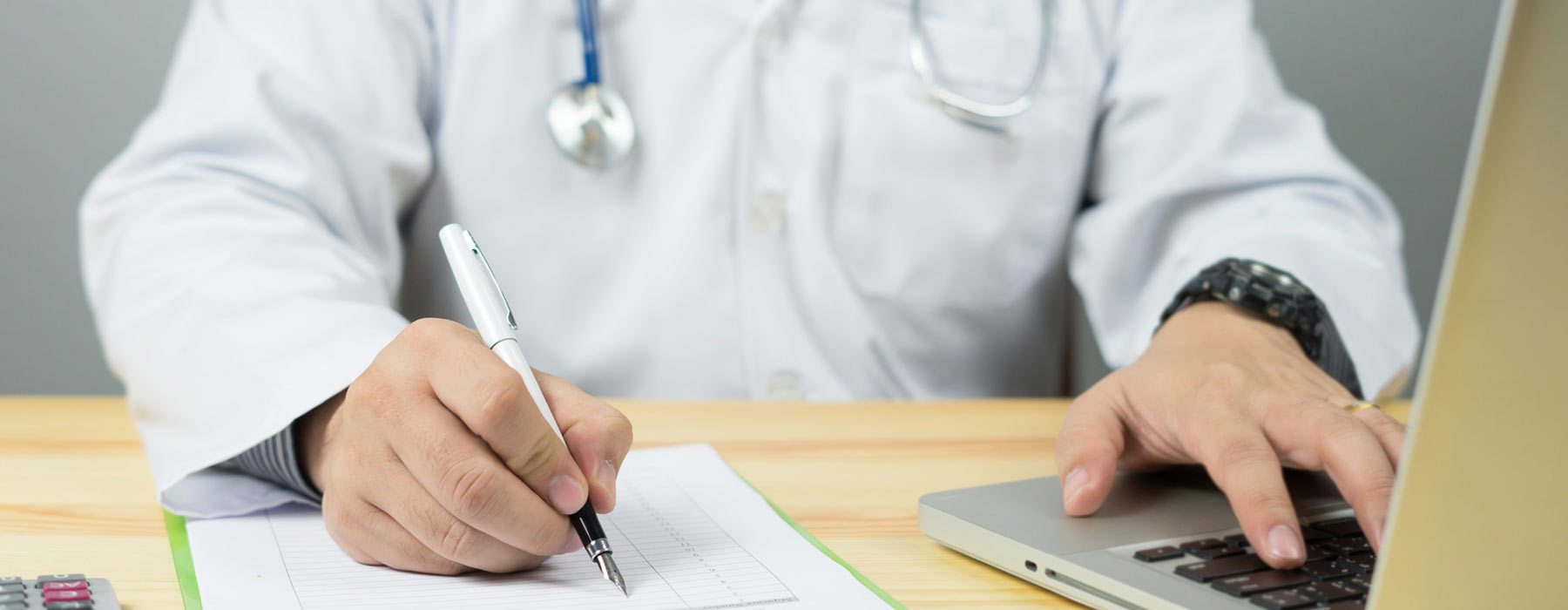 man with stethoscope filing paperwork